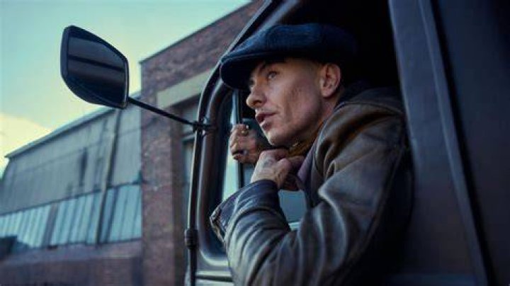 Barry Keoghan looking out a balcony after a wild night in Emerald Fennell's 'Saltburn'.